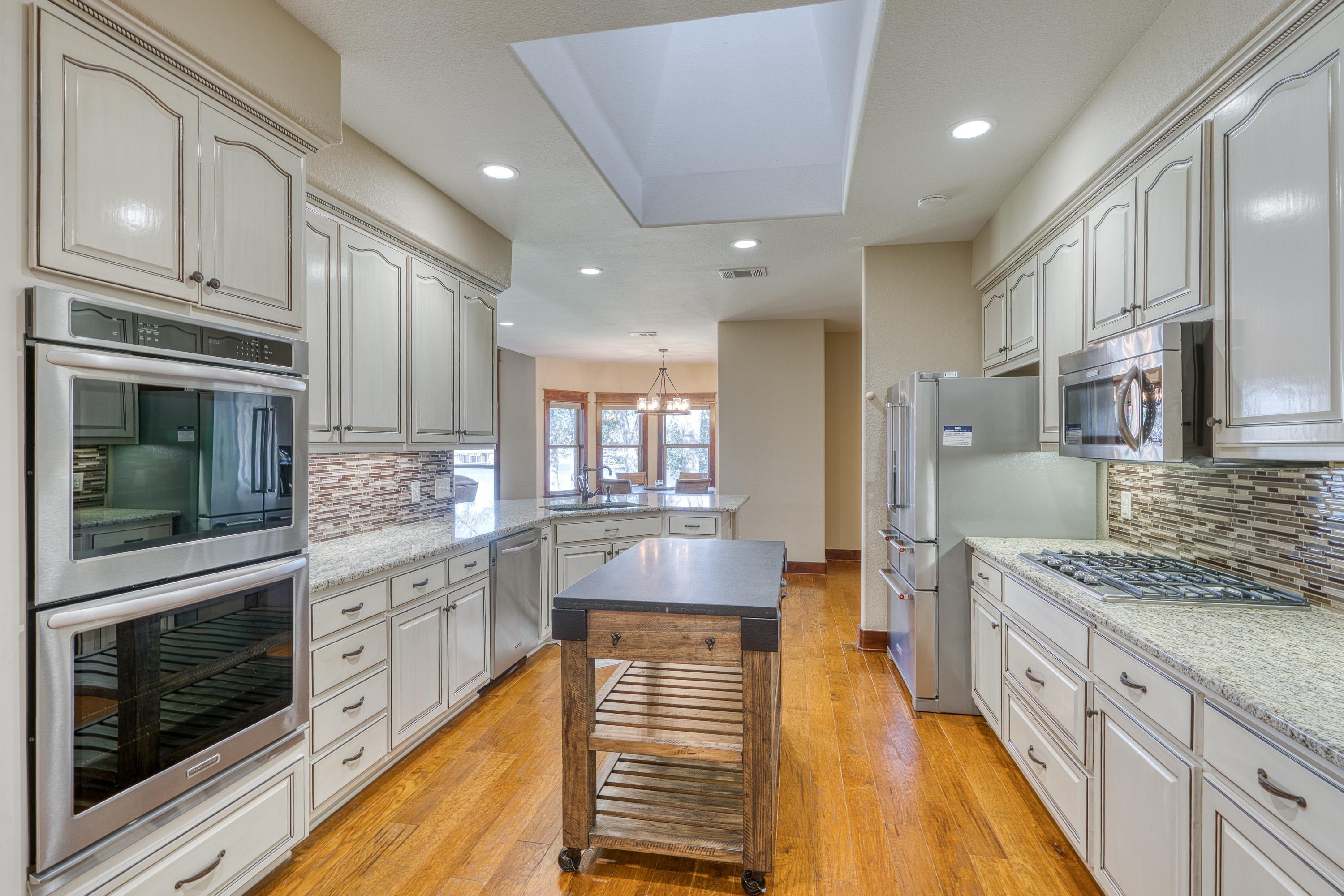 206 River Ranch Road Kingsland, TX 78639 - Photo 13 of 30 a large kitchen with stainless steel appliances granite countertop a stove and a sink