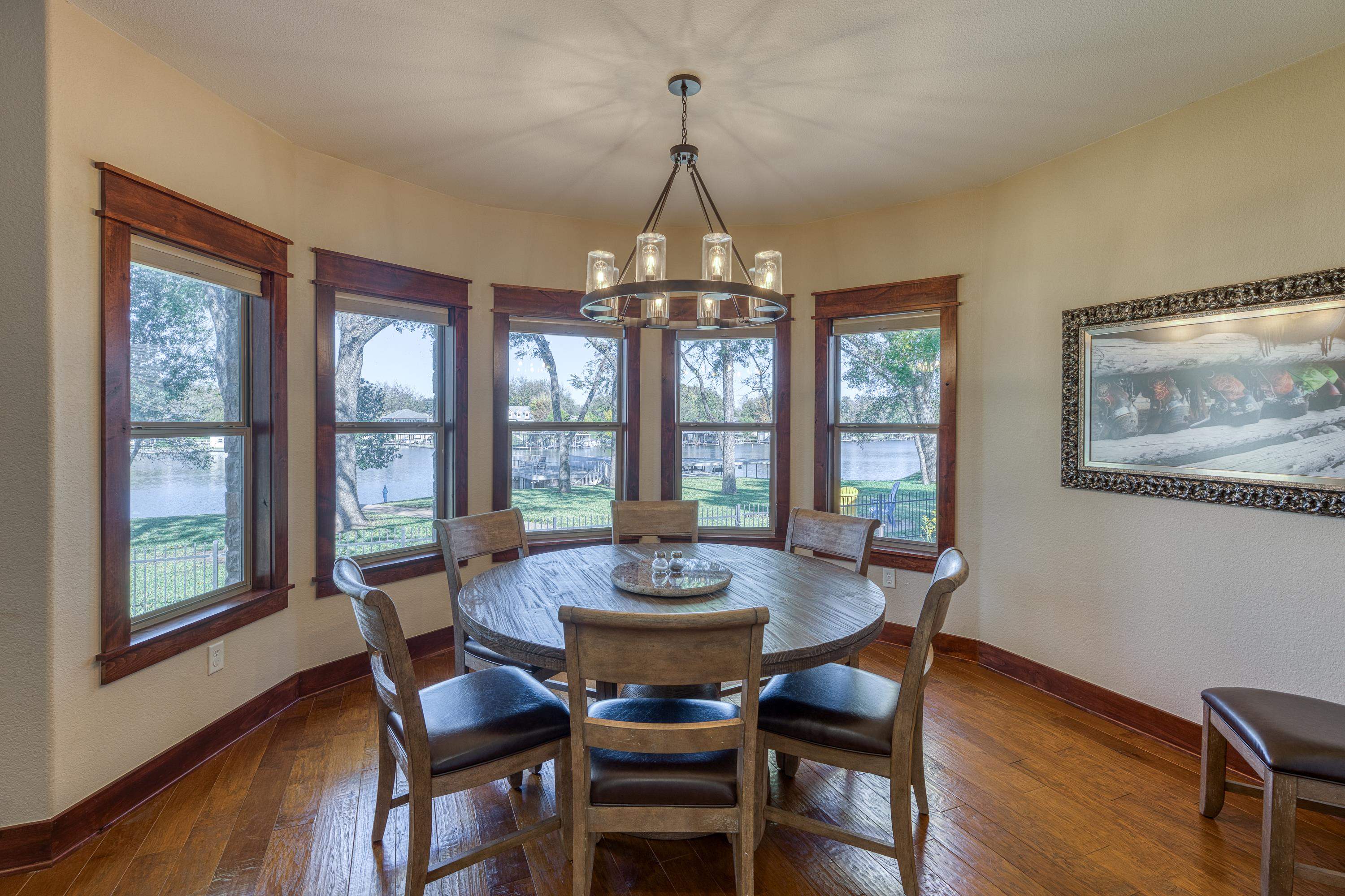 206 River Ranch Road Kingsland, TX 78639 - Photo 14 of 30 a dining room with furniture a chandelier and wooden floor
