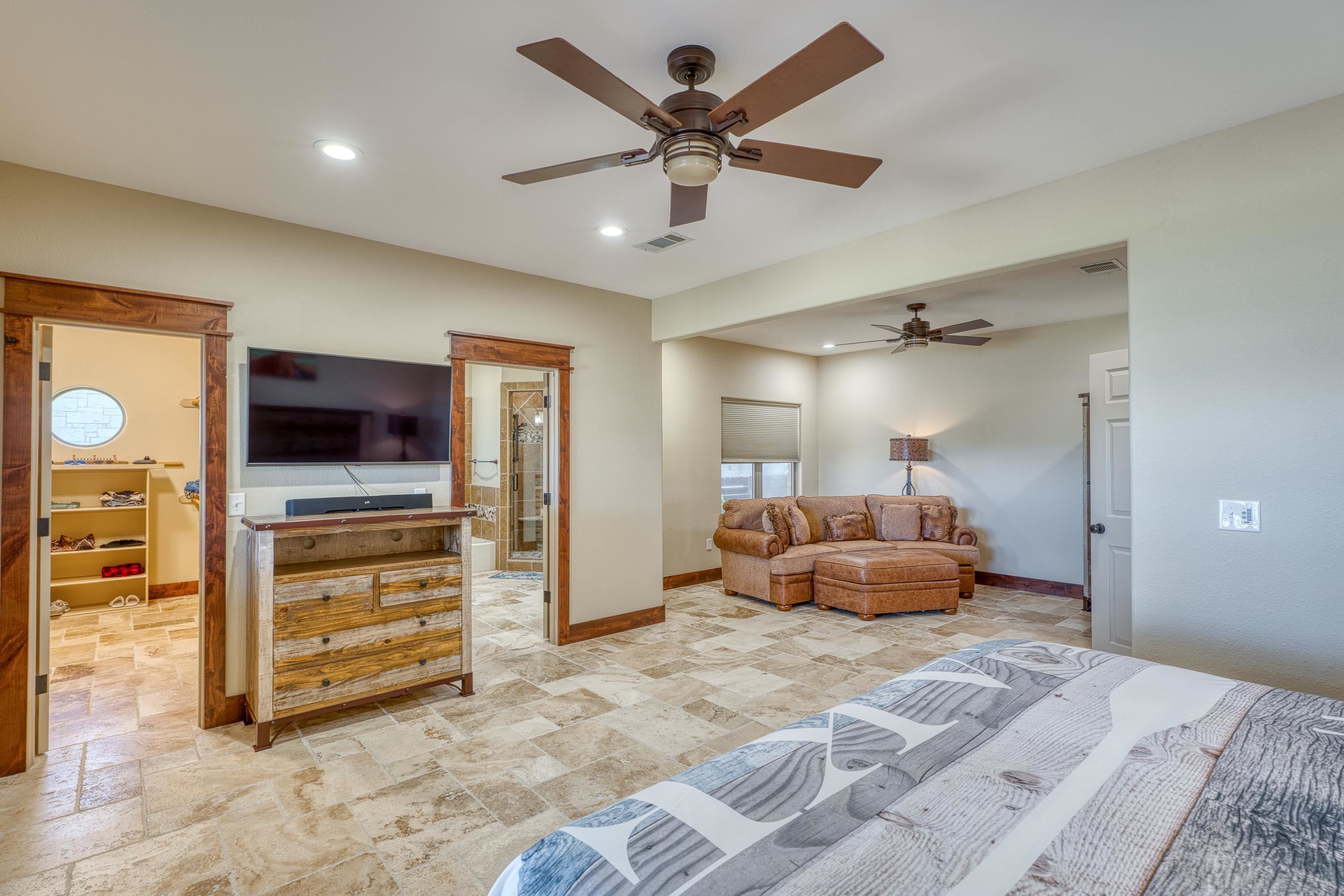 206 River Ranch Road Kingsland, TX 78639 - Photo 17 of 30 a bedroom with furniture and a flat screen tv