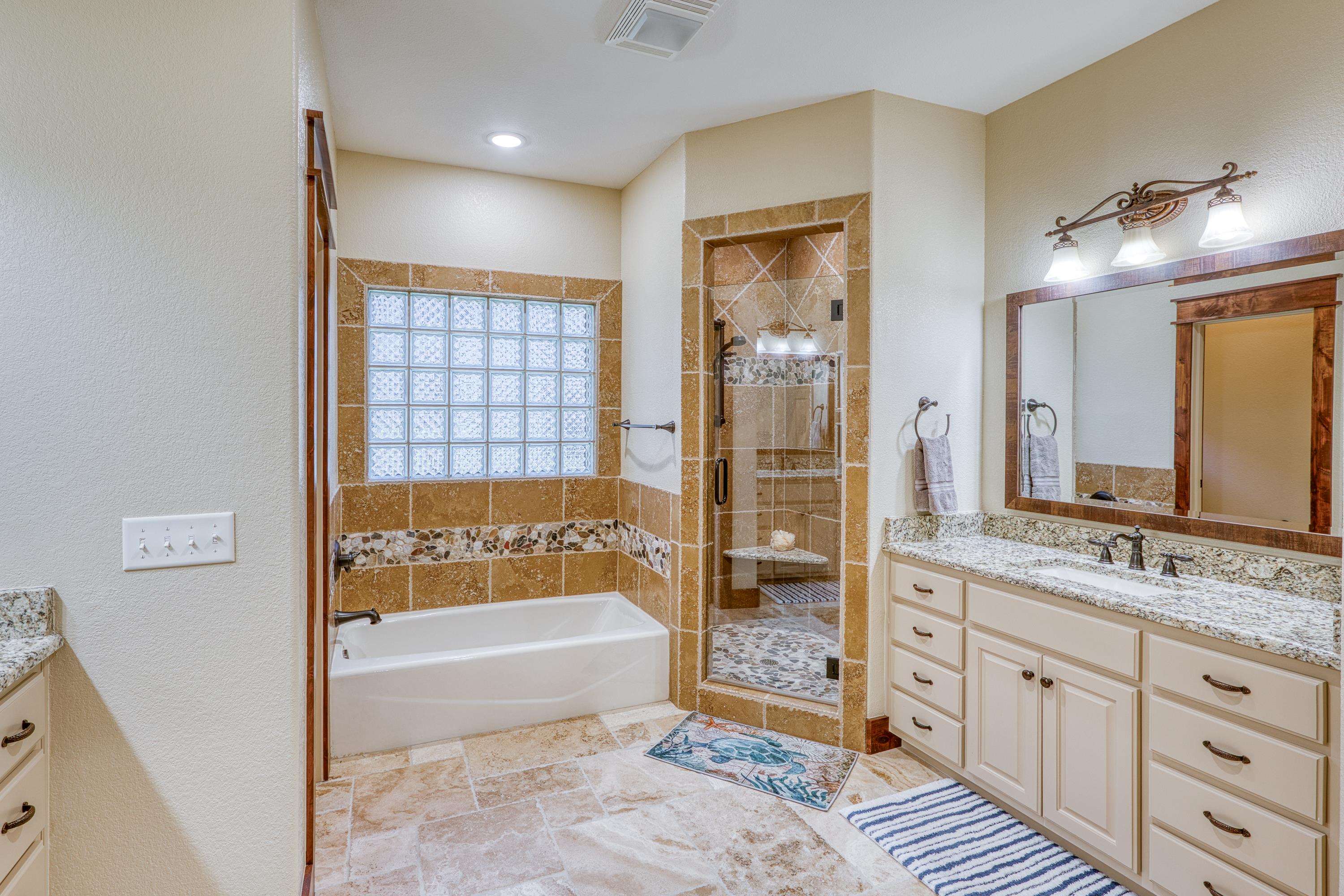 206 River Ranch Road Kingsland, TX 78639 - Photo 18 of 30 a spacious bathroom with a tub sink and mirror