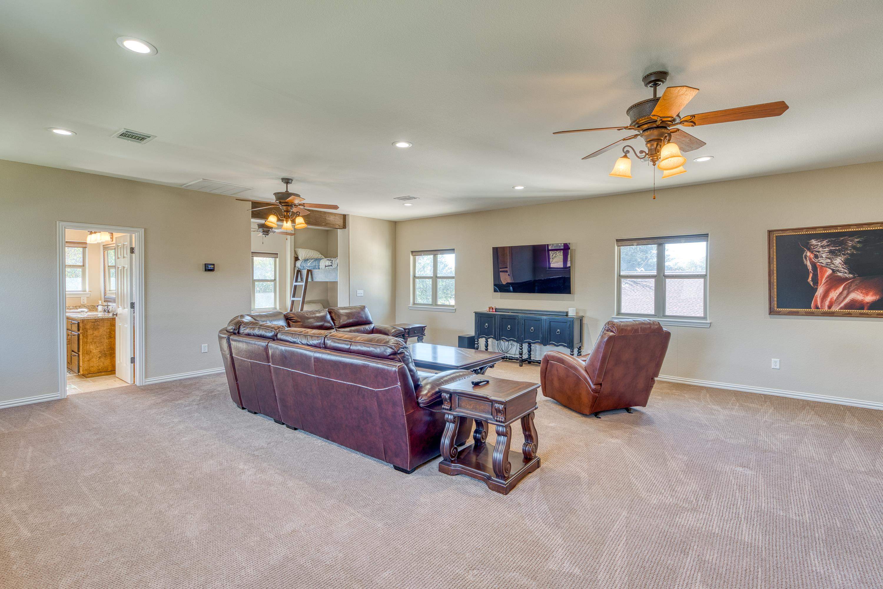 206 River Ranch Road Kingsland, TX 78639 - Photo 26 of 30 a living room with furniture a ceiling fan and a window