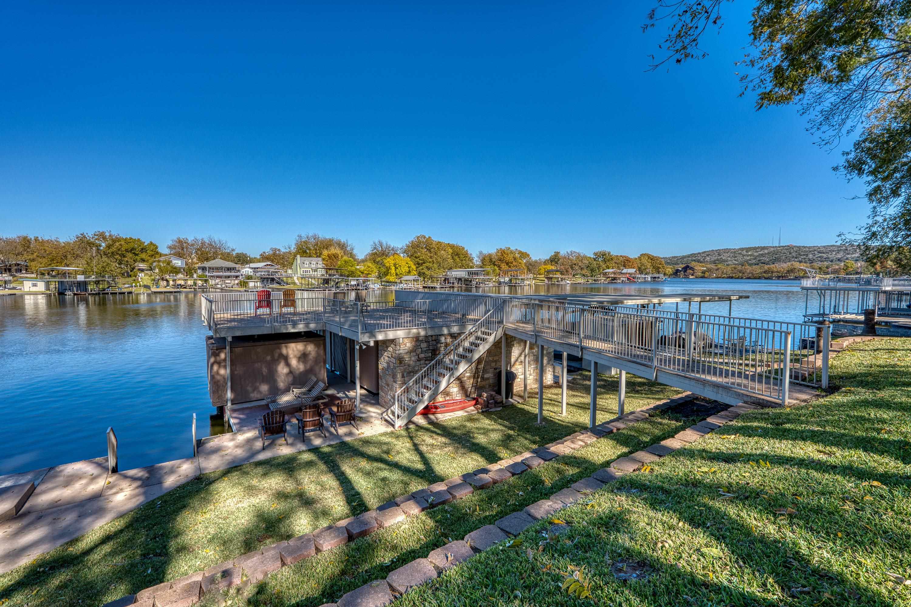 206 River Ranch Road Kingsland, TX 78639 - Photo 27 of 30 a view of a lake with a house in the background