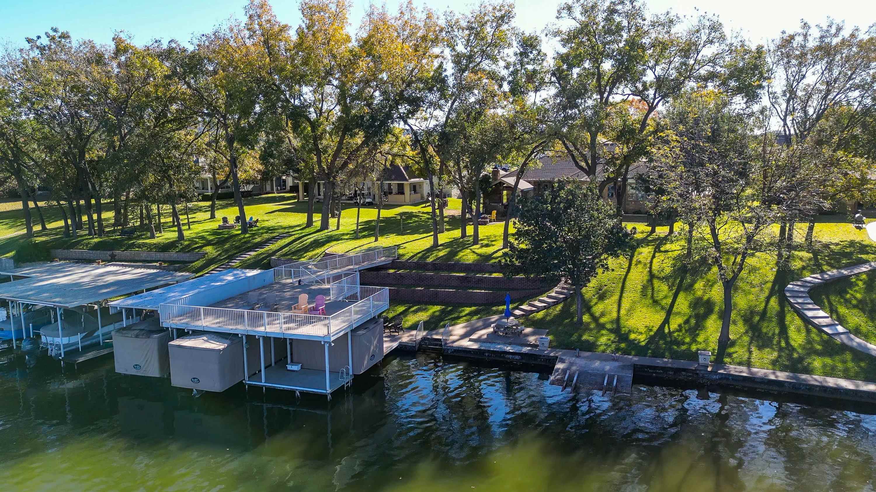 206 River Ranch Road Kingsland, TX 78639 - Photo 28 of 30 a aerial view of a house with swimming pool and large trees