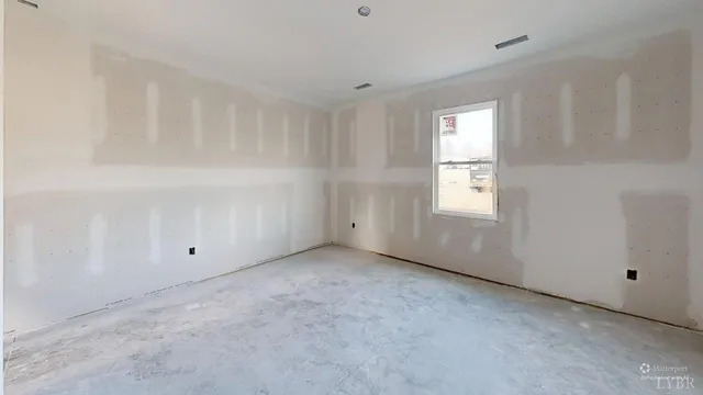 a view of an empty room with a window