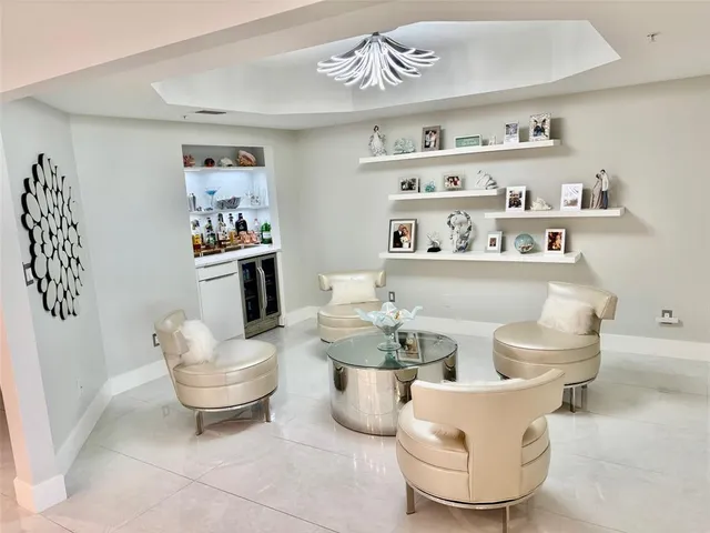 a living room with furniture and a painting on the wall