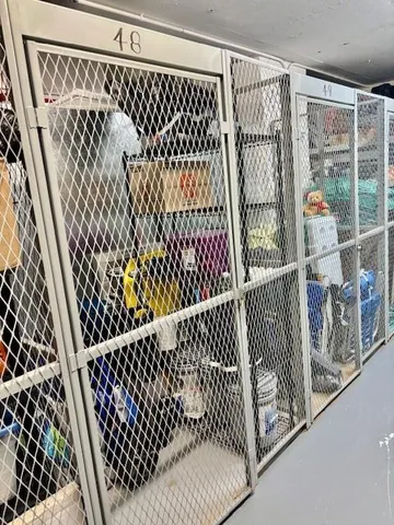 a view of a black gate with wooden floor