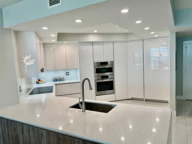 a kitchen with stainless steel appliances a refrigerator and a sink