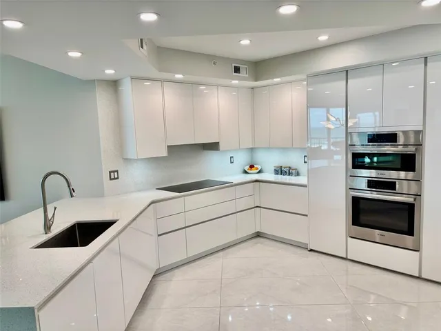 a kitchen with stainless steel appliances kitchen island granite countertop a sink and cabinets