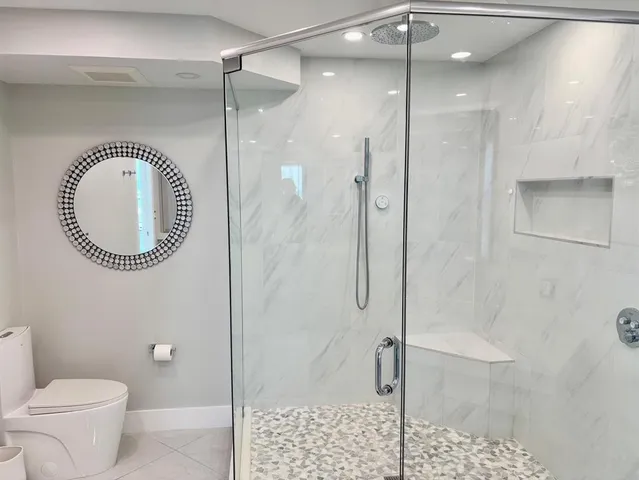 a bathroom with a toilet a sink and a shower