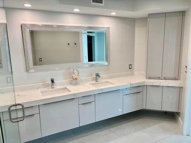 a bathroom with a double vanity sink and a mirror