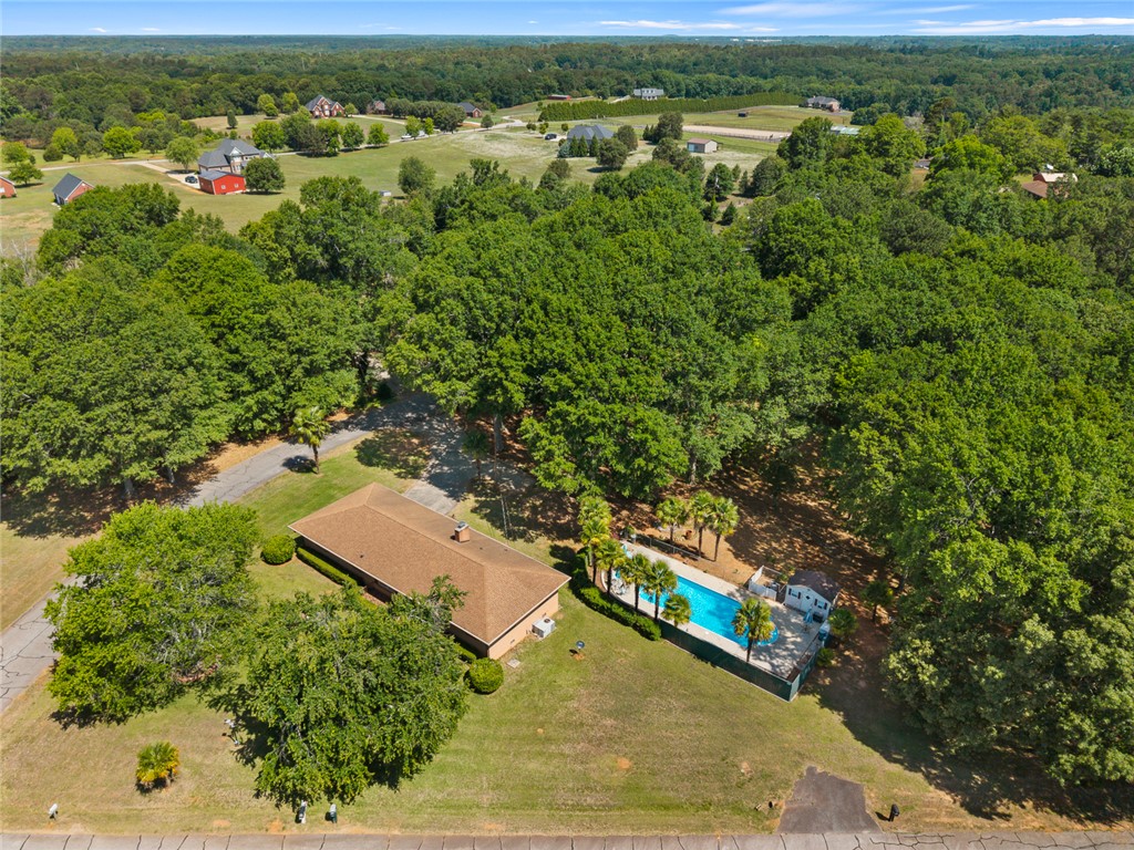 2101 Old Spring Drive Anderson, SC 29625 - Photo 32 of 36 An aerial perspective reveals a charming residence nestled amidst a verdant landscape, featuring a sparkling in-ground pool.