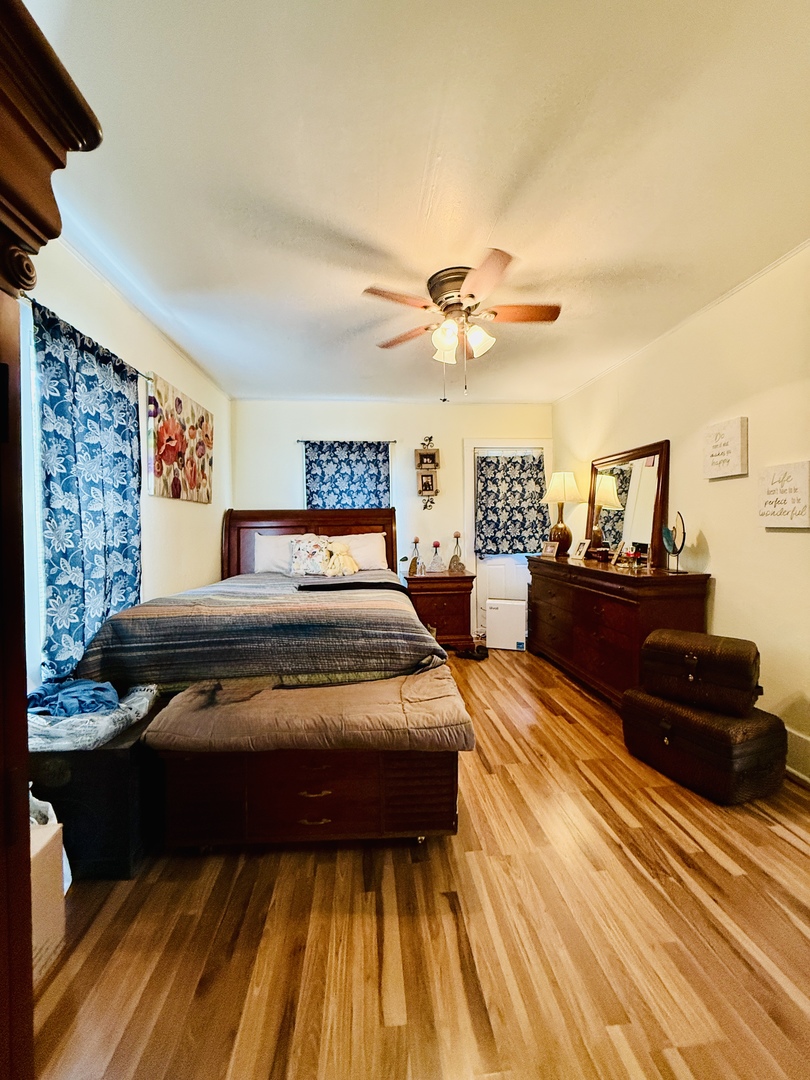 423 Maple Street Marengo, IL 60152 - Photo 11 of 17 a bedroom with a bed and wooden floor