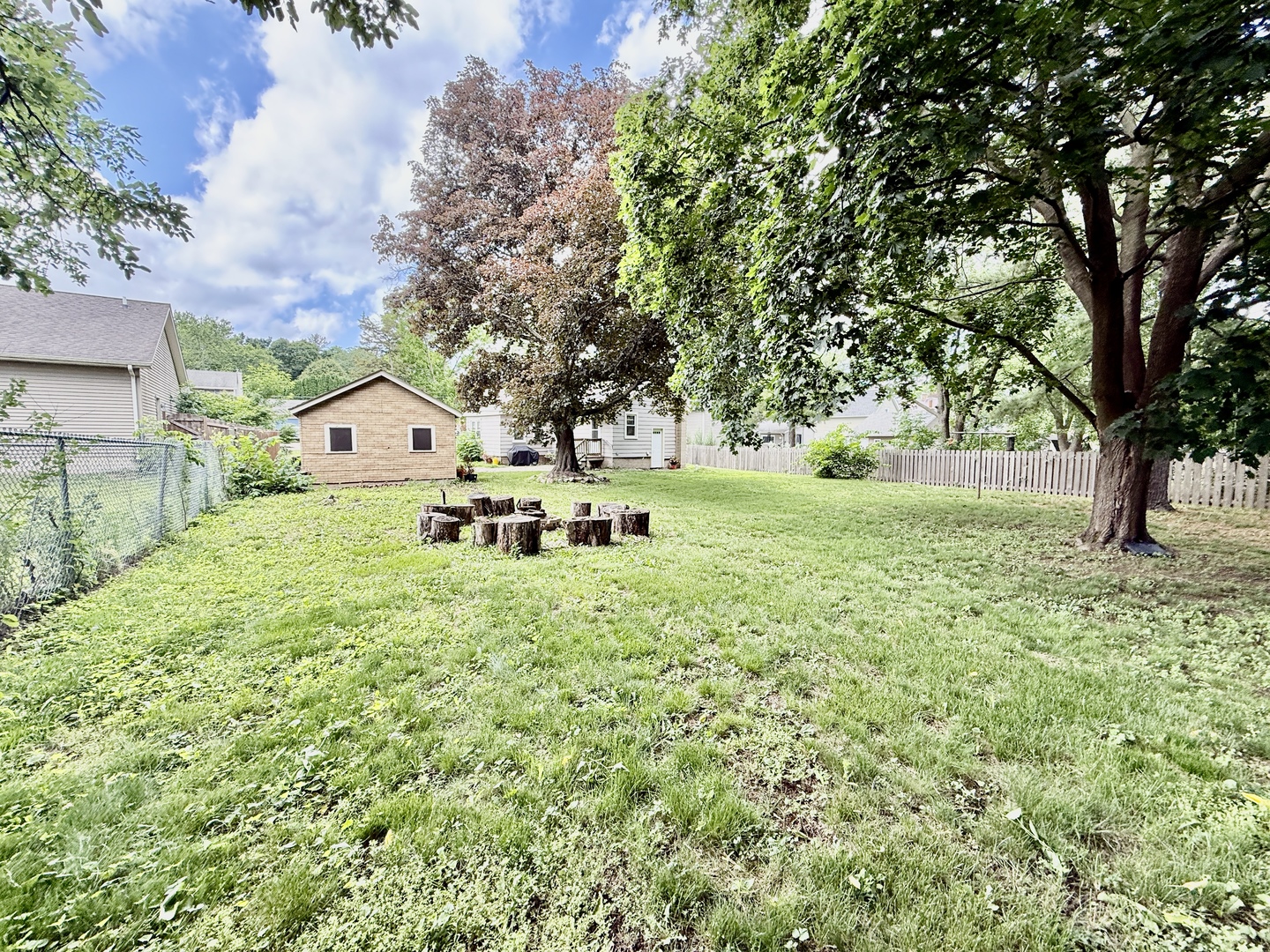 423 Maple Street Marengo, IL 60152 - Photo 3 of 17 a backyard of a house with table and chairs
