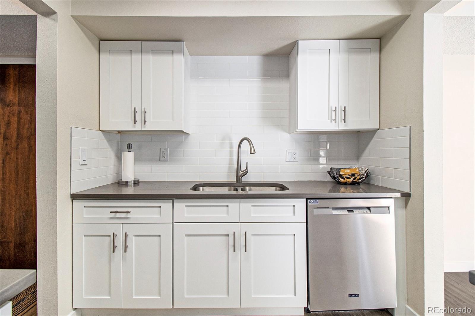 500 Manhattan Drive, Unit B1 Boulder, CO 80303 - Photo 11 of 24 a kitchen with white cabinets