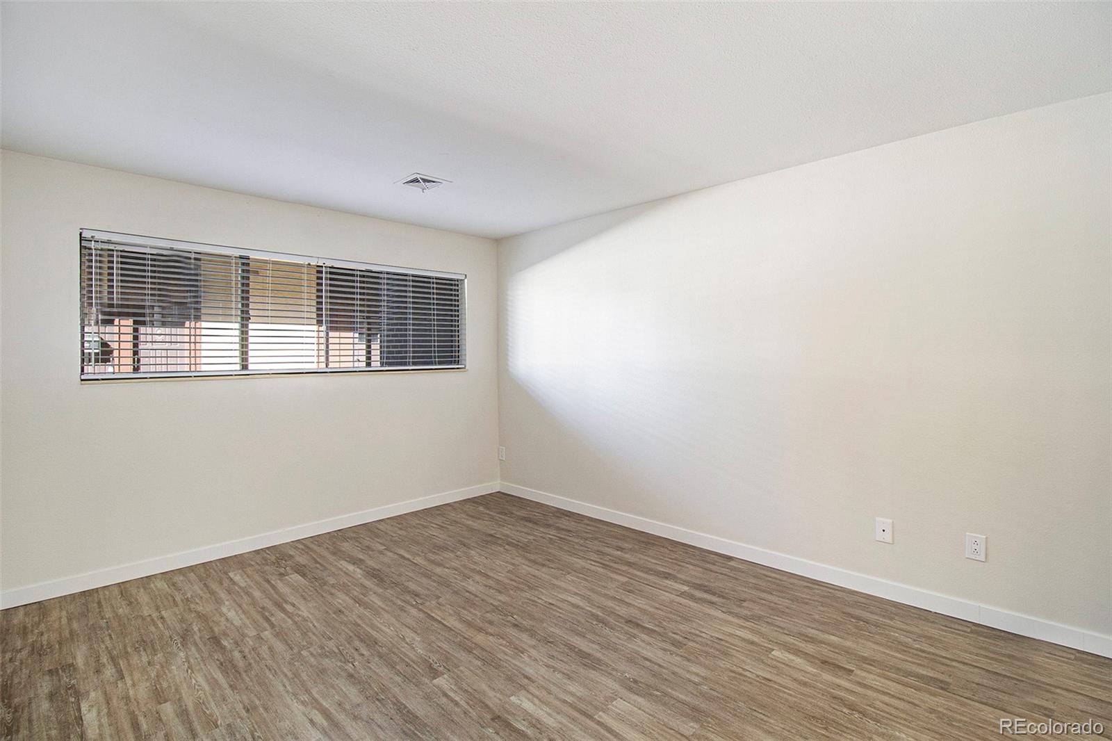 500 Manhattan Drive, Unit B1 Boulder, CO 80303 - Photo 13 of 24 a view of empty room with wooden floor and fan