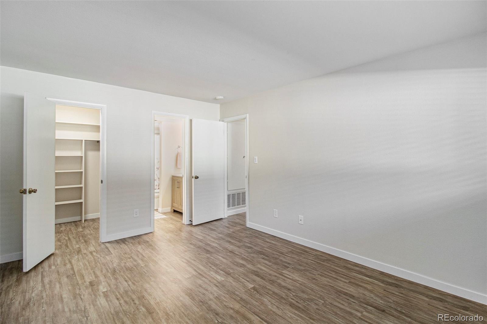 500 Manhattan Drive, Unit B1 Boulder, CO 80303 - Photo 14 of 24 a view of an empty room with wooden floor & closet