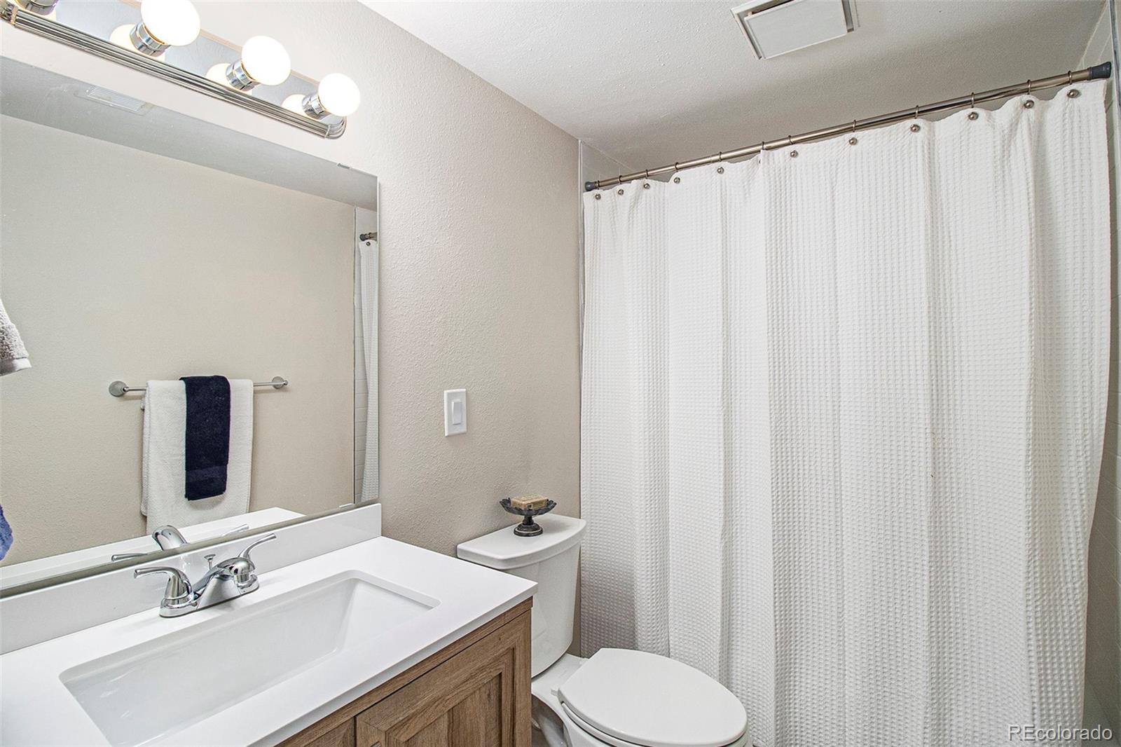 500 Manhattan Drive, Unit B1 Boulder, CO 80303 - Photo 15 of 24 a bathroom with a sink a toilet and shower curtain