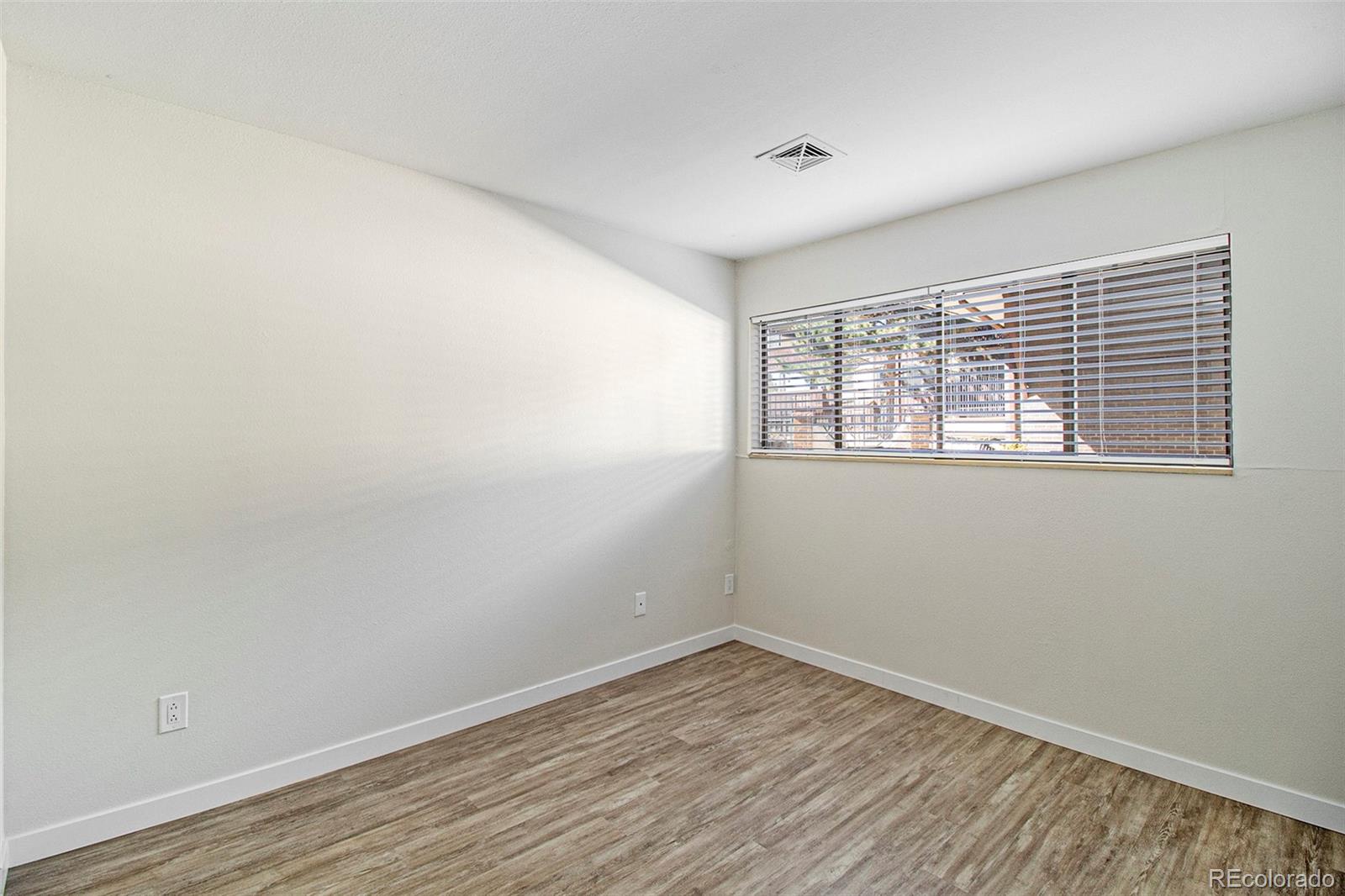 500 Manhattan Drive, Unit B1 Boulder, CO 80303 - Photo 18 of 24 a view of empty room with wooden floor and fan