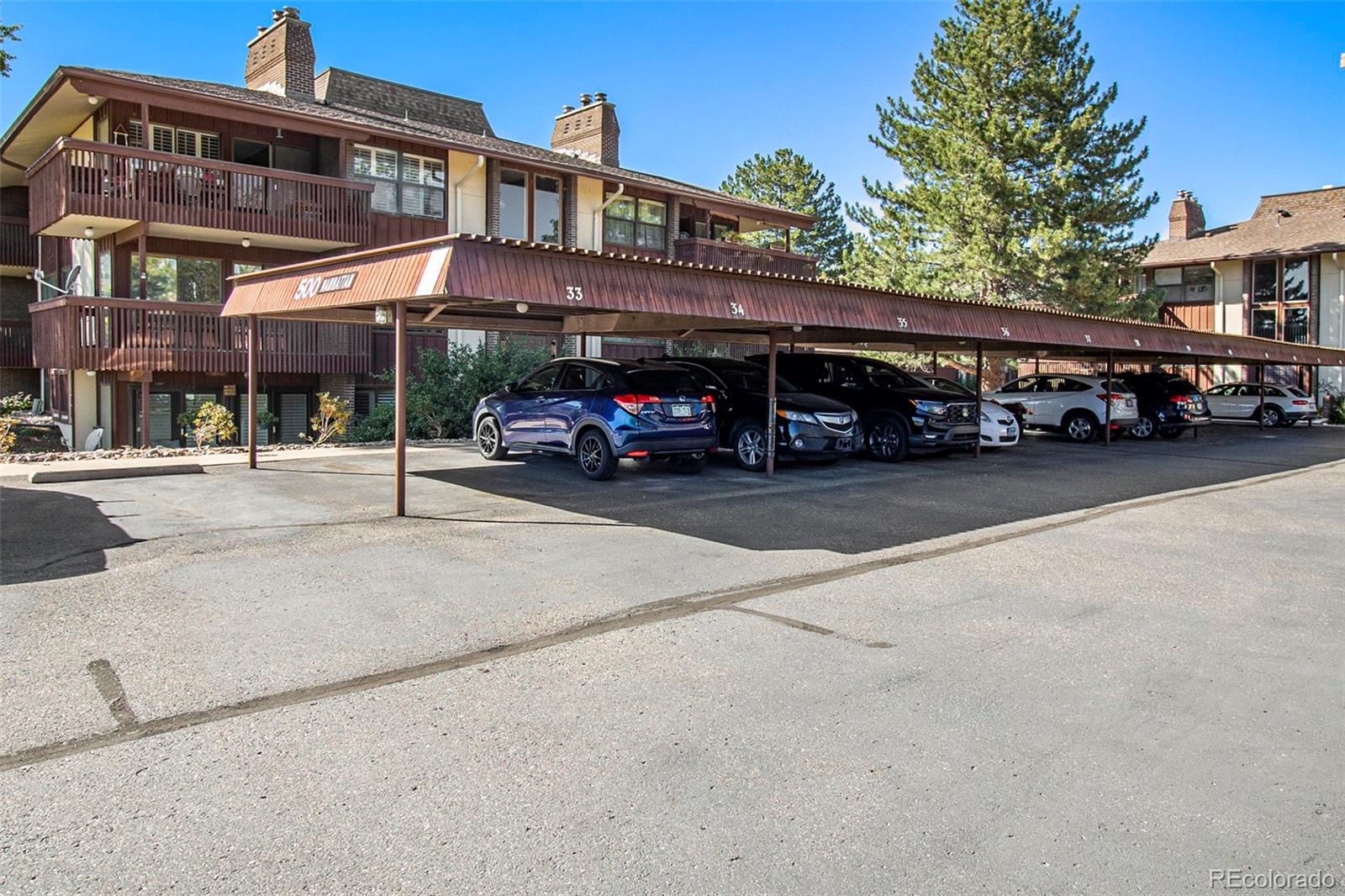 500 Manhattan Drive, Unit B1 Boulder, CO 80303 - Photo 23 of 24 a view of a street that has couple of cars parked on the road