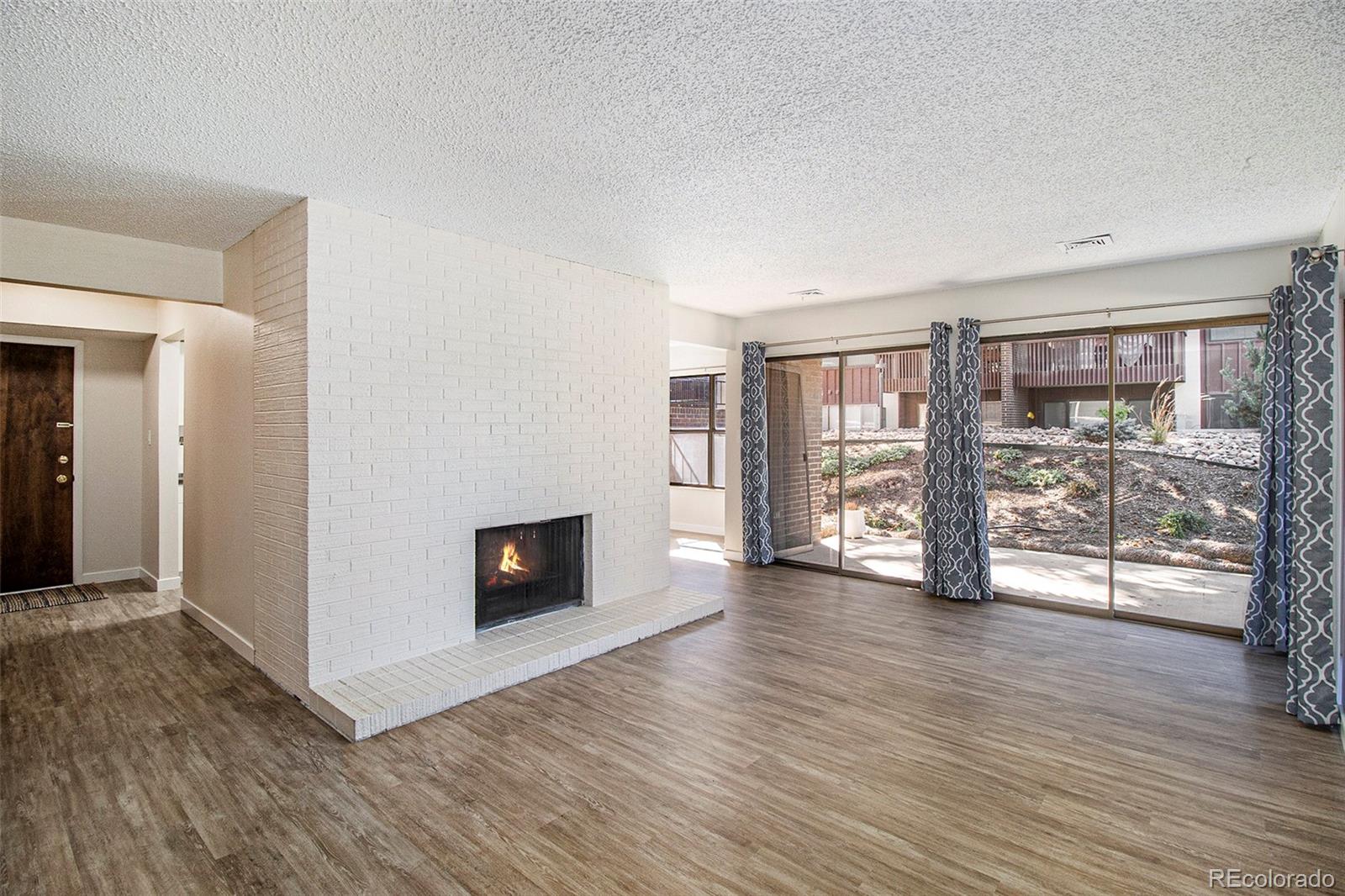 500 Manhattan Drive, Unit B1 Boulder, CO 80303 - Photo 3 of 24 a view of an empty room with wooden floor and a window