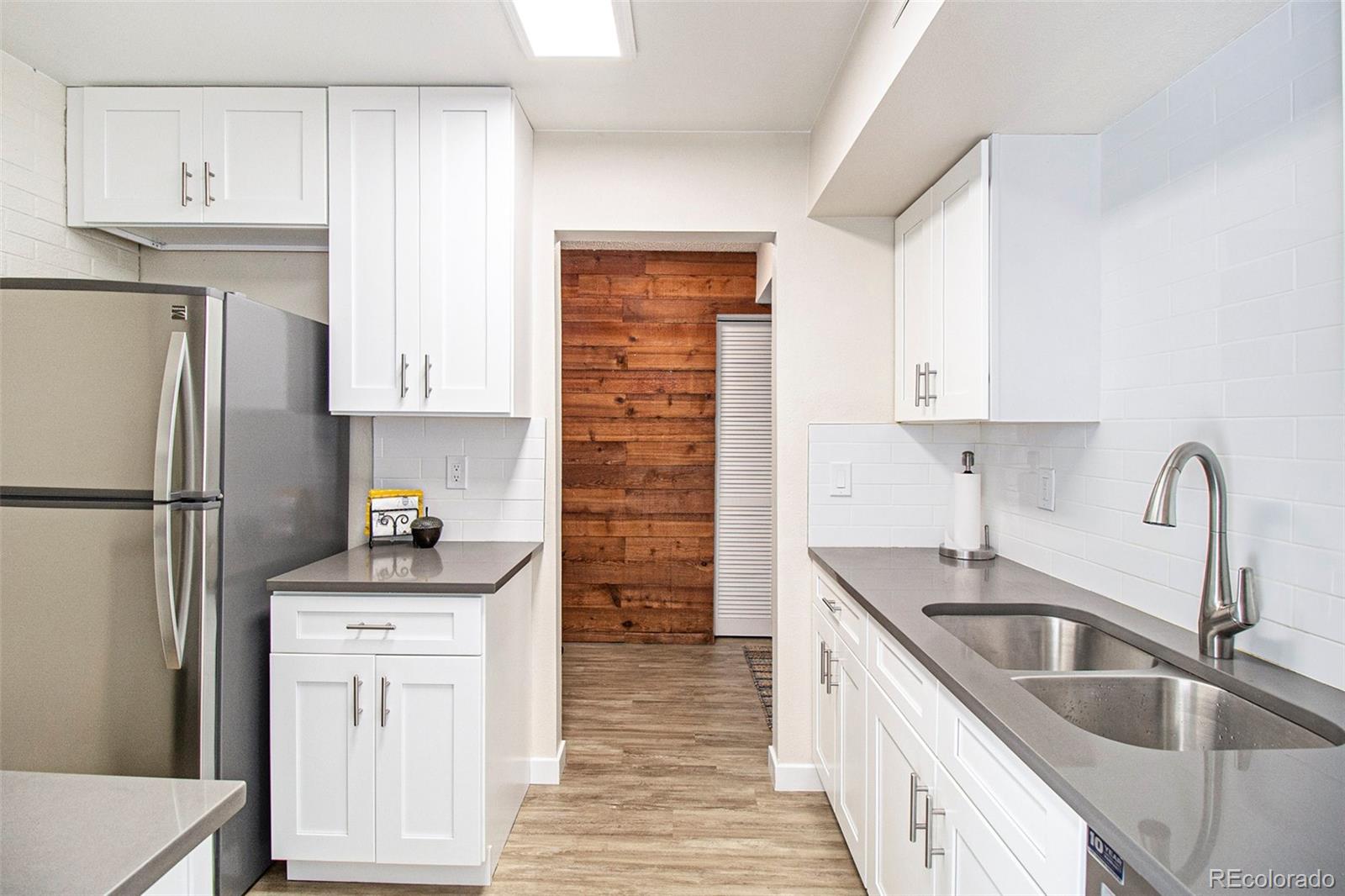 500 Manhattan Drive, Unit B1 Boulder, CO 80303 - Photo 8 of 24 a kitchen with refrigerator cabinets and a sink