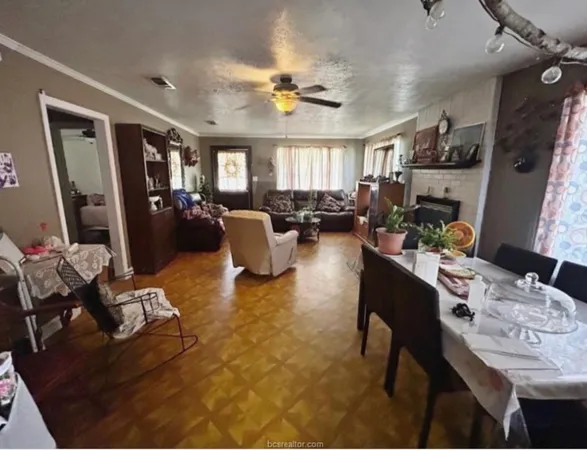 a living room with fireplace furniture and a flat screen tv