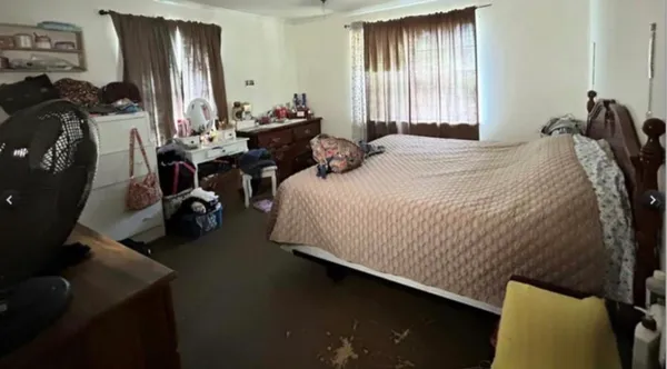 a bedroom with bed and a window