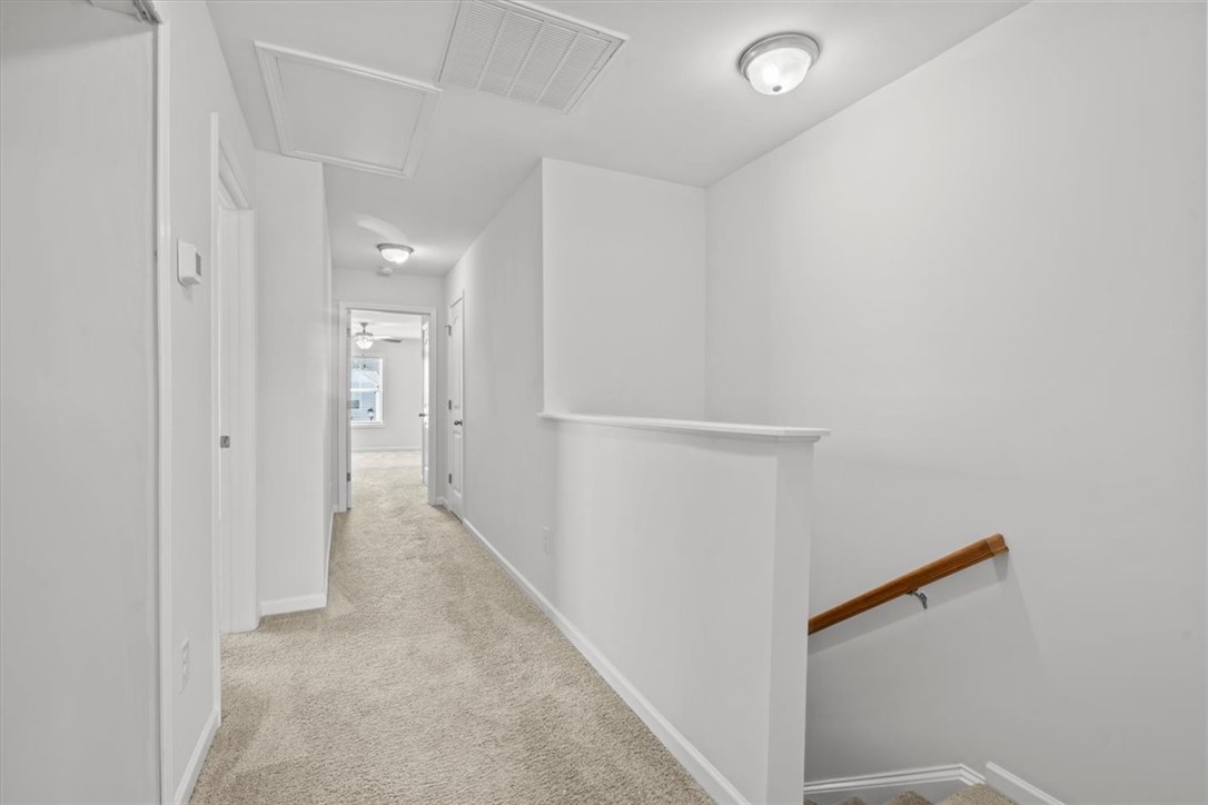 118 Adger Road Pendleton, SC 29670 - Photo 12 of 31 This spacious hallway features plush carpeting and convenient access to multiple rooms, creating an inviting flow.