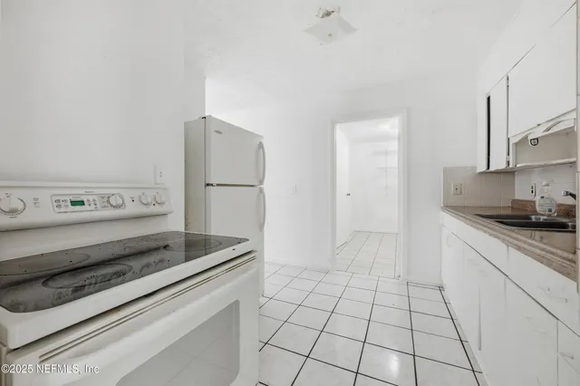 a kitchen with appliances and cabinets