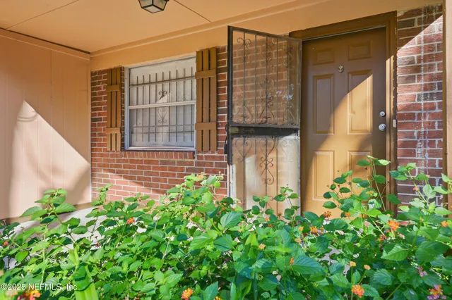 a view of a house with a flower garden