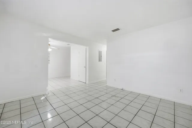 a view of an empty room and wooden floor