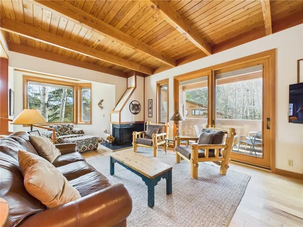 a living room with furniture a table and chairs next to a window