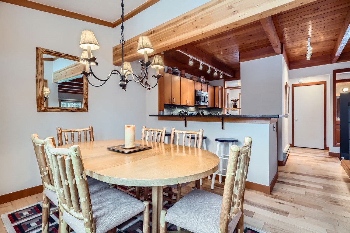 620 Tennis Club Road, Unit 1339 Keystone, CO 80435 - Photo 18 of 49 A bright and inviting dining space featuring rustic log furniture, a stylish chandelier, and an open layout that flows seamlessly into the kitchen.