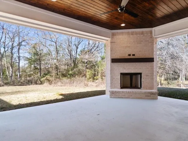 a view of a hallway with wooden floor and a living room
