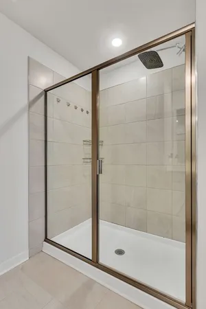 a bathroom with a glass shower door
