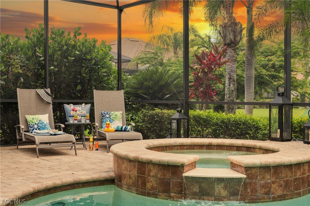 9383 Slate Court Naples, FL 34120 - Photo 4 of 28 a view of a swimming pool with a patio