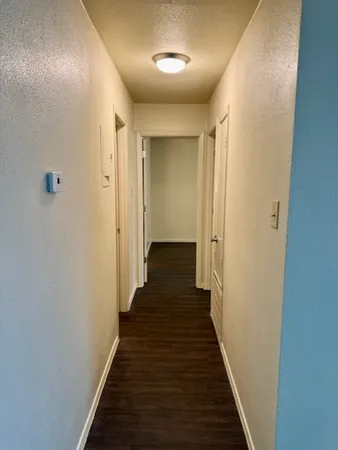 a view of a hallway with the wooden floor