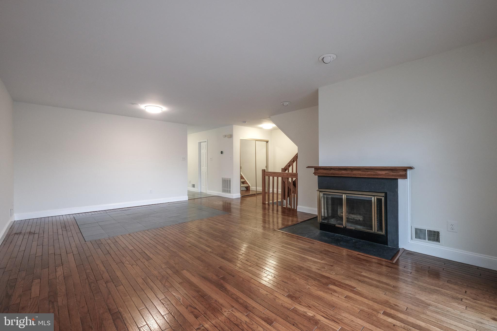 35 C Chicopee Drive Princeton, NJ 08540 - Photo 3 of 24 a view of an empty room with wooden floor fireplace and a window