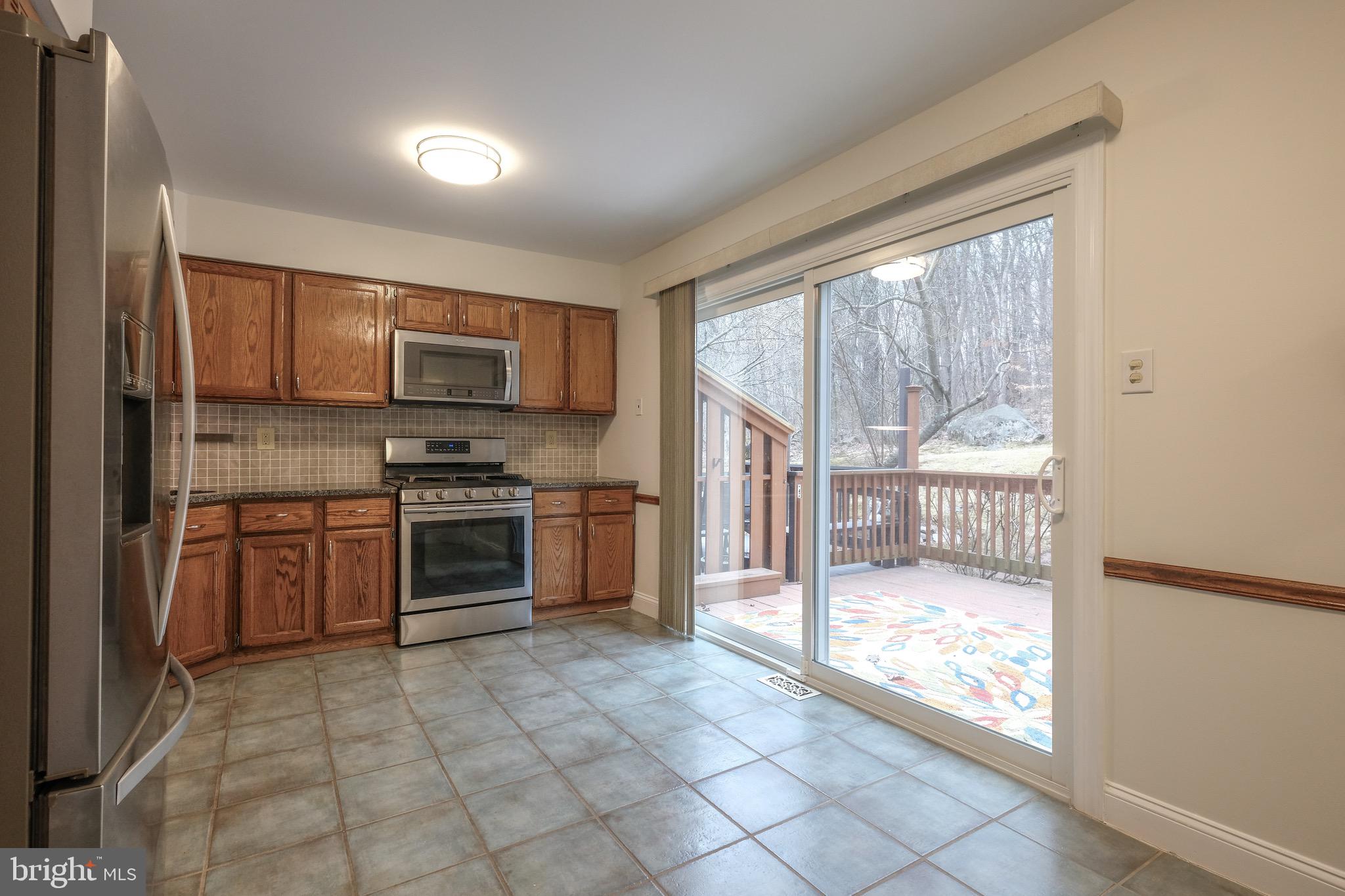 35 C Chicopee Drive Princeton, NJ 08540 - Photo 7 of 24 a kitchen with stainless steel appliances a stove top oven and a refrigerator