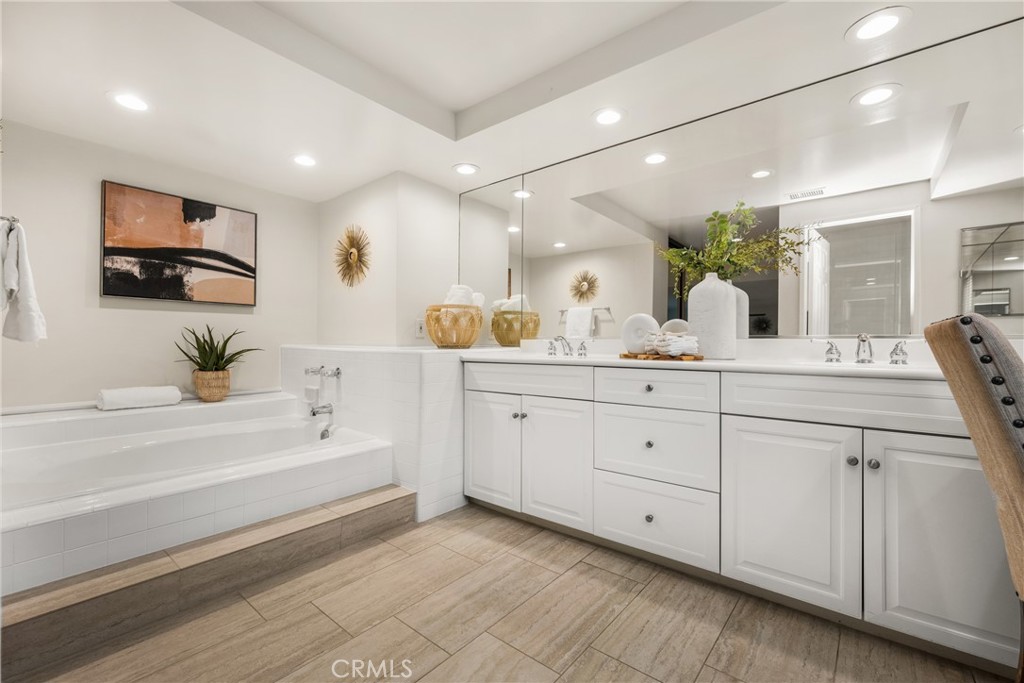 4 Abeto Irvine, CA 92620 - Photo 14 of 29 a spacious bathroom with double vanity a mirror and a bathtub
