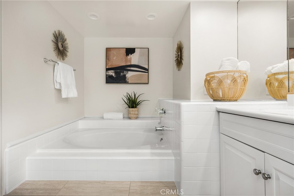 4 Abeto Irvine, CA 92620 - Photo 15 of 29 a bathroom with a bathtub a mirror and vanity