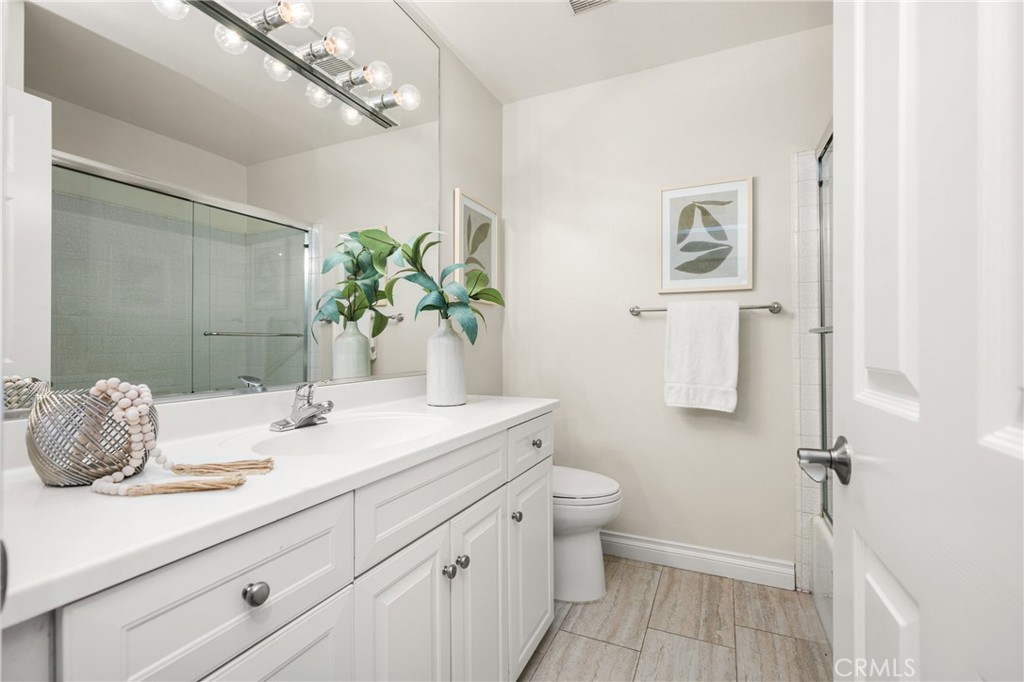 4 Abeto Irvine, CA 92620 - Photo 18 of 29 a bathroom with a granite countertop sink a toilet and a mirror