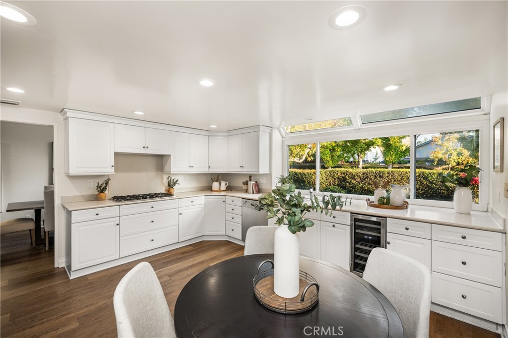 4 Abeto Irvine, CA 92620 - Photo 6 of 29 a kitchen with white cabinets and dining table
