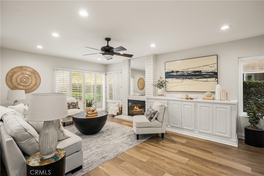 4 Abeto Irvine, CA 92620 - Photo 9 of 29 a living room with furniture a fireplace and a potted plant