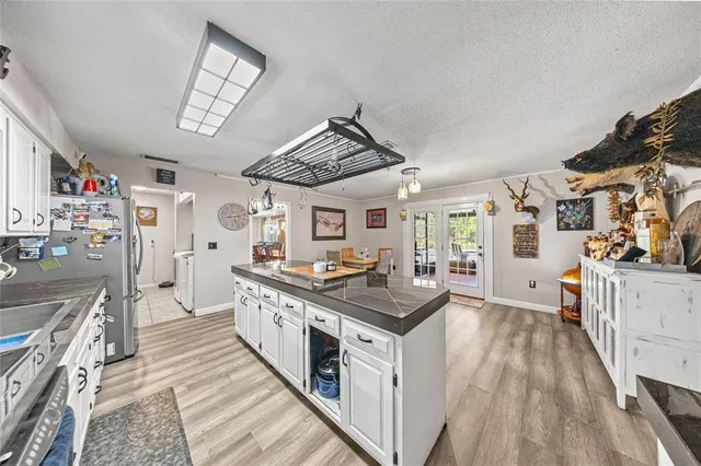 a kitchen with stainless steel appliances granite countertop a stove and cabinets