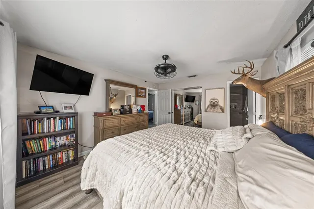 a bed room with a bed and a television