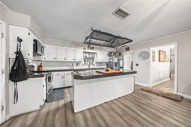 a kitchen with stainless steel appliances a sink and stove top oven