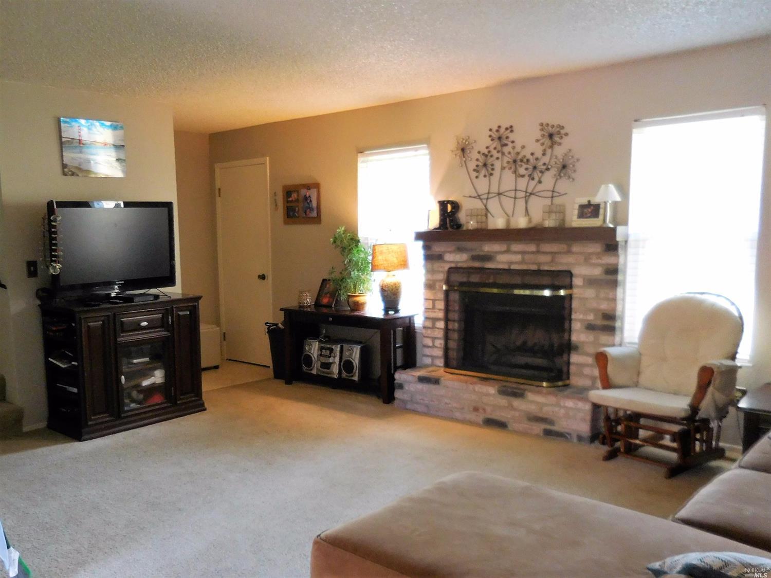 1308 Gold Way Rohnert Park, CA 94928 - Photo 1 of 1 a living room with furniture a fireplace and a flat screen tv