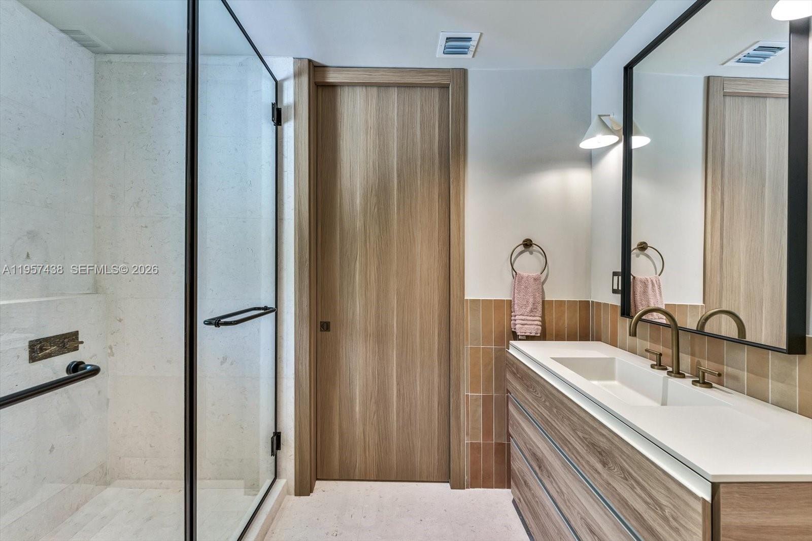 5902 Southwest 105th Street Pinecrest, FL 33156 - Photo 18 of 30 a bathroom with a sink and a mirror
