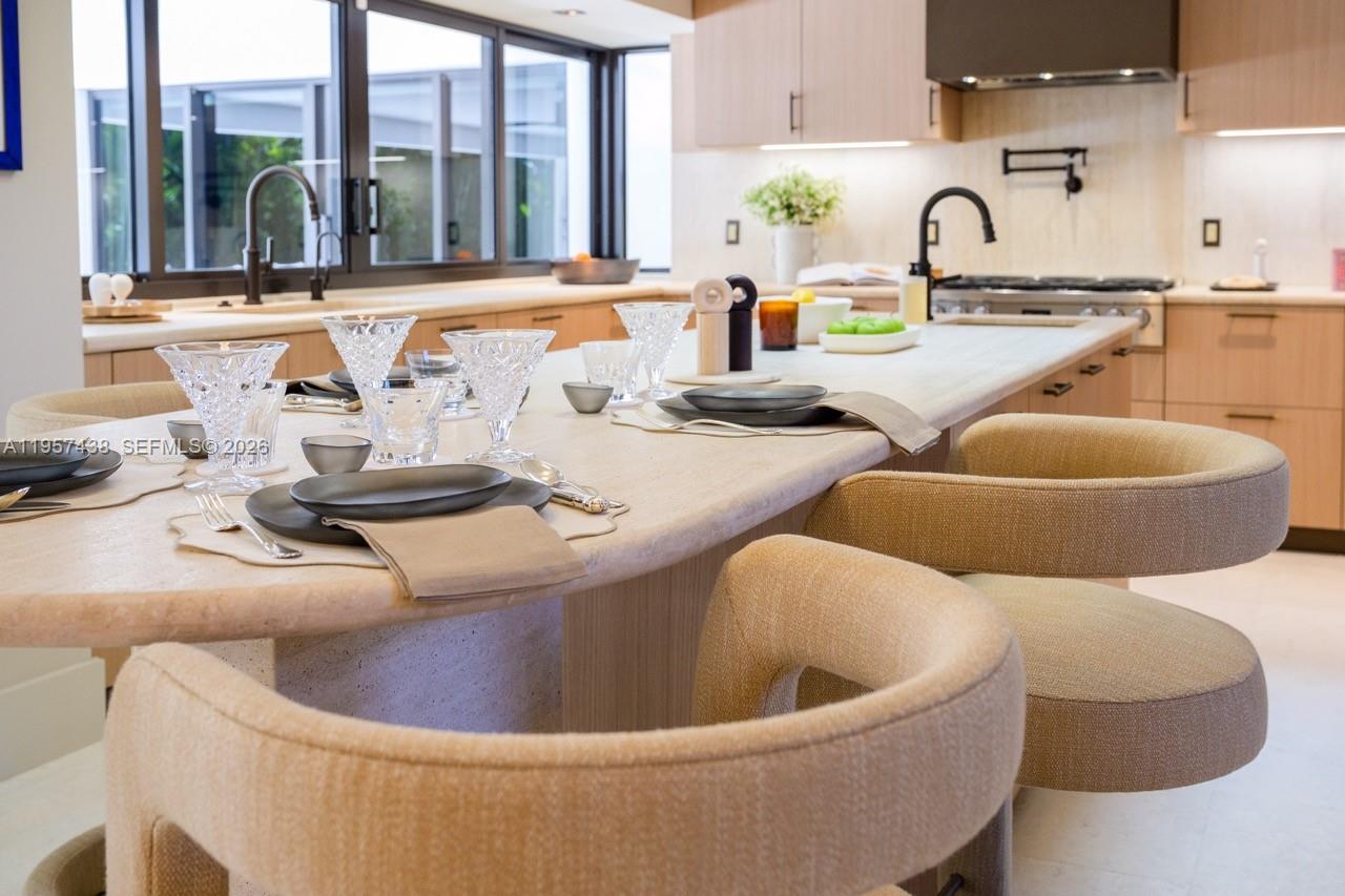 5902 Southwest 105th Street Pinecrest, FL 33156 - Photo 21 of 31 a large white kitchen with a granite countertop sink and a large window
